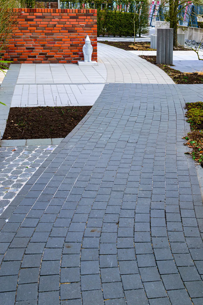 Paver walkway winding through a garden