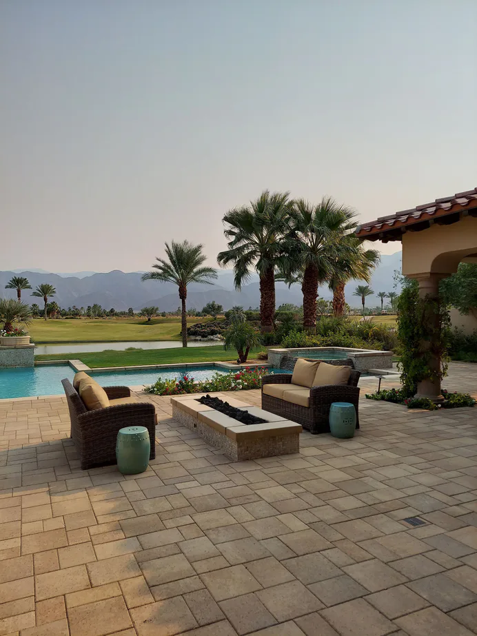 Paver pool deck with coping around a swimming pool